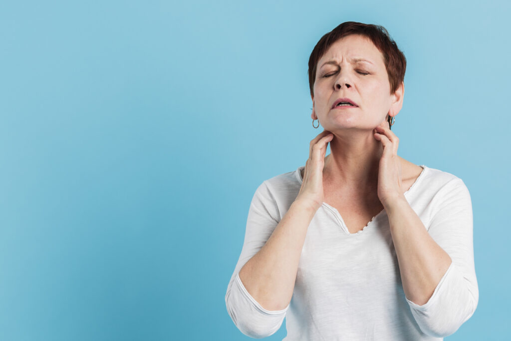 Woman feeling lymph glands in neck